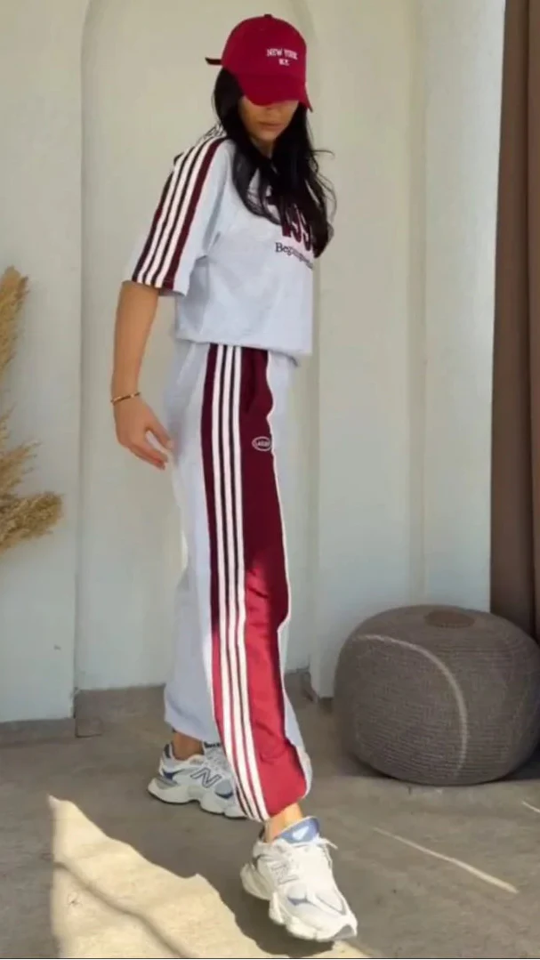 Grey 1993 graphic sweatshirt and matching wide-leg track pants set paired with white chunky sneakers 03