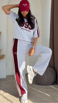 Grey 1993 graphic sweatshirt and matching wide-leg track pants set paired with white chunky sneakers 05