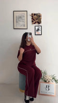 Nike two-piece tracksuit featuring a short-sleeved top and matching track pants with thin white side piping 01
