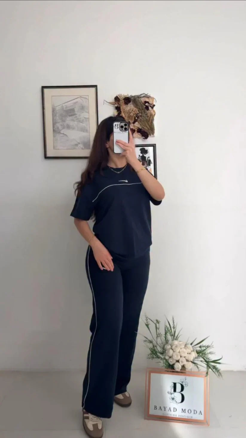 Nike two-piece tracksuit featuring a short-sleeved top and matching track pants with thin white side piping 04