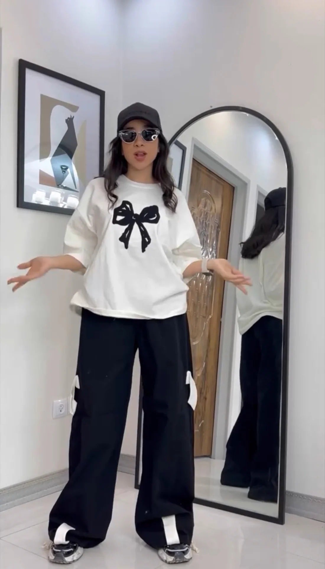 Oversized drop-shoulder t-shirt with a center ribbon bow graphic paired with wide-leg cargo trousers 05