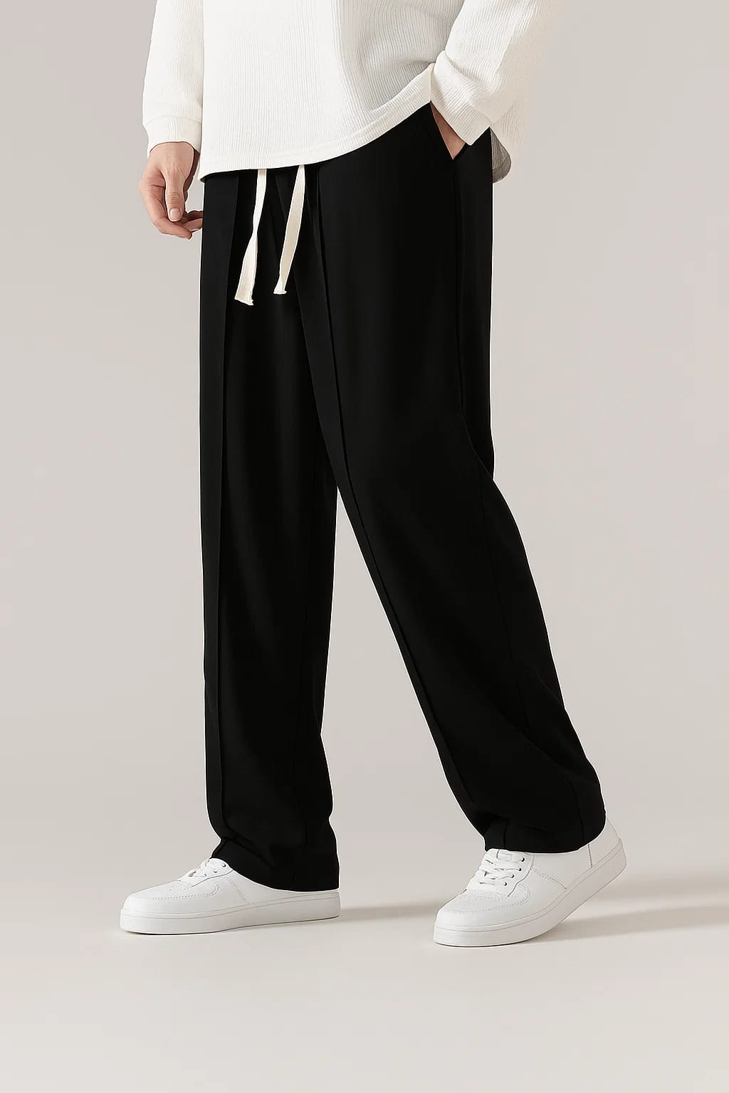 Full-length view of men's Classic Black wide-leg trousers with a comfortable baggy fit and white sneakers