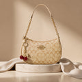 Signature Beige Coach Shoulder Bag with Cherry keychain