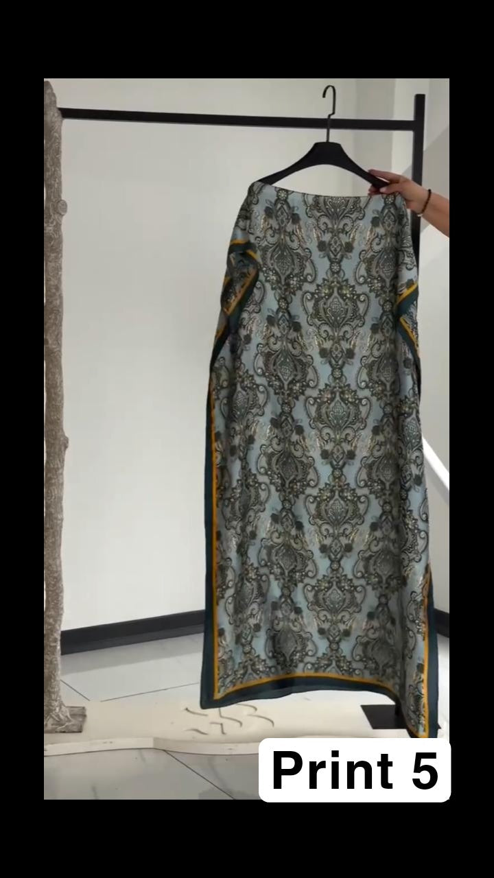 Vibrant multi-colored circular print kaftan with a bright orange border, displayed on a clothing rack 04