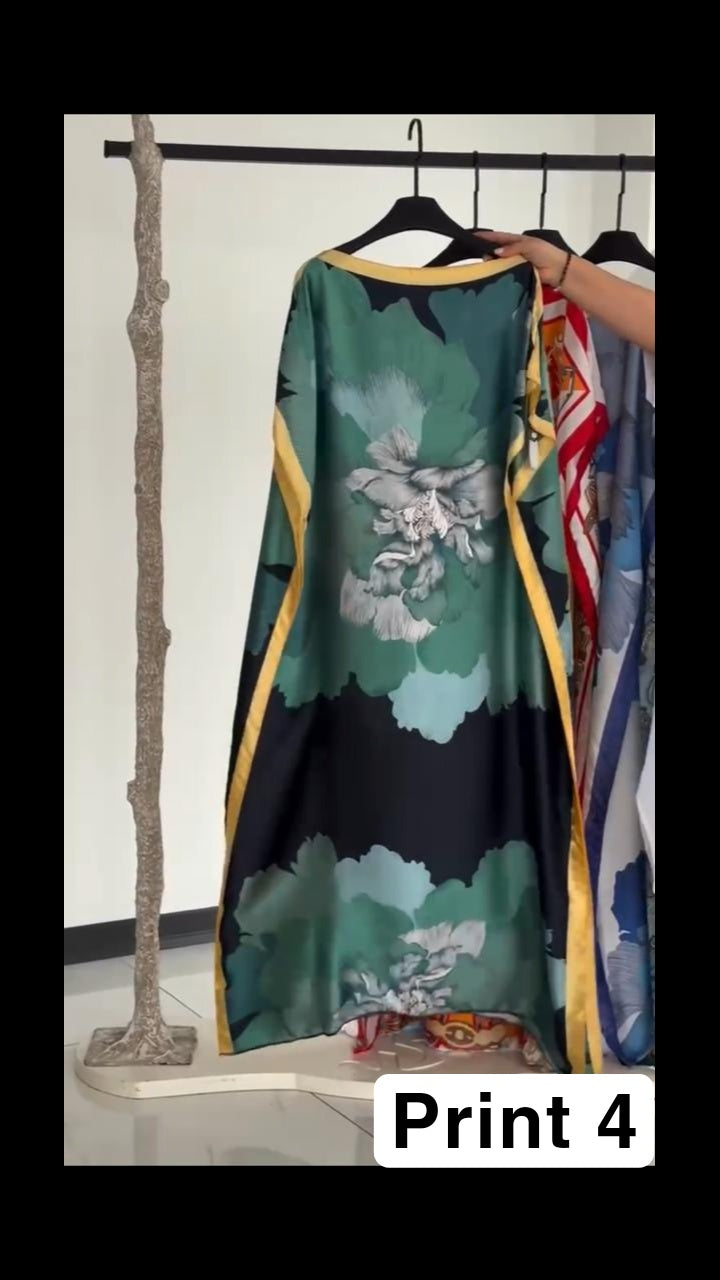 Vibrant multi-colored circular print kaftan with a bright orange border, displayed on a clothing rack 05