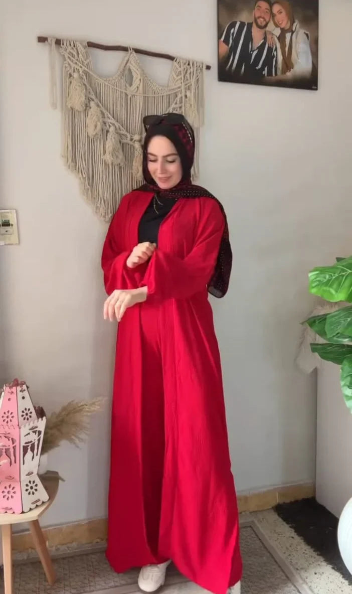 Woman wearing a chic beige three-piece modest ensemble with a long cardigan, wide-leg trousers, and a bold leopard print hijab 02