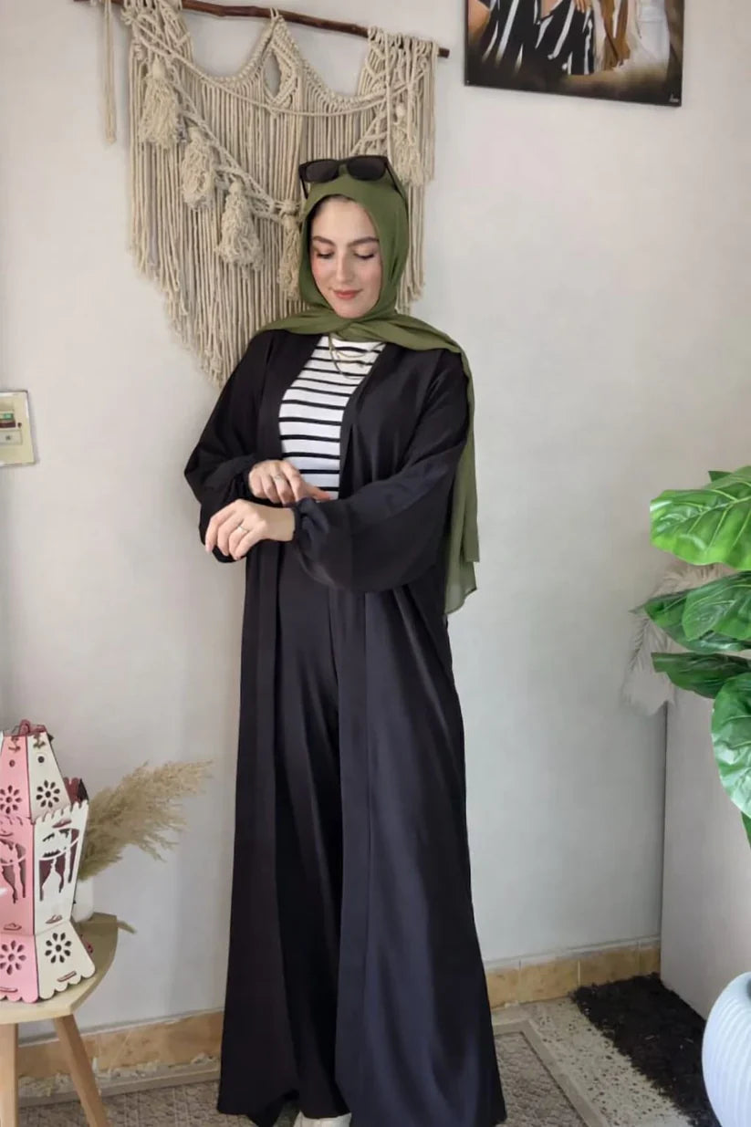 Woman wearing a chic beige three-piece modest ensemble with a long cardigan, wide-leg trousers, and a bold leopard print hijab 03