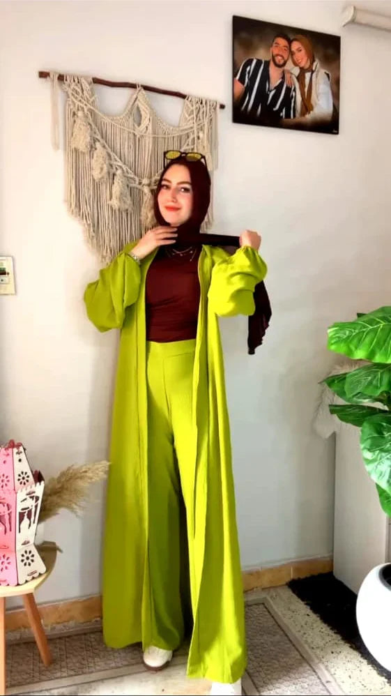 Woman wearing a chic beige three-piece modest ensemble with a long cardigan, wide-leg trousers, and a bold leopard print hijab 04